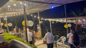 a group of people standing under a tent with balloons at La Florida Hotel in El Colegio +139 photos