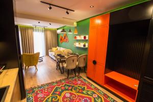 a living room with a table and a dining room at Brilant Luxury Apartment in Gjirokastër