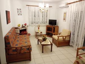 a living room with a couch and a chair at Katerina Apartments in Flogita