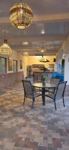 a lobby with a table and chairs and chandeliers at Finca El Monasterio in Rivas