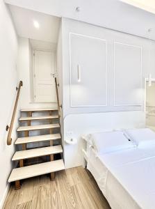 a bedroom with a staircase and a bed at Napoleon in Tropea