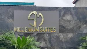 a sign on the side of a building at MILLENIUM SUITES - Piscine privée in Yamoussoukro