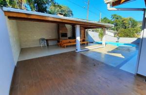 a view of a house with a patio and a swimming pool at Casa da Palmeira com Piscina in Piratuba