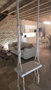 a living room with a couch and a swing at Love room- Le Cocon Osé in Autun
