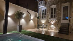 a house with a hot tub in a yard at night at Love room- Le Cocon Osé in Autun