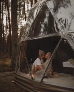 two people sitting inside of a tent at Rum nore in Disah