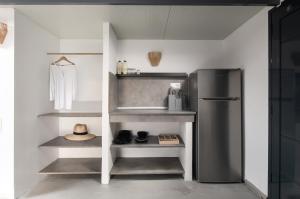 a kitchen with a stainless steel refrigerator and shelves at Villa Miranda Roshi in Toroni
