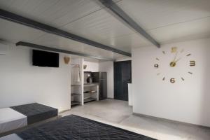 a bedroom with a large clock on a wall at Villa Miranda Roshi in Toroni