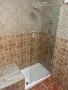 a shower with a glass door in a bathroom at Lucia Home in Moya +12 photos