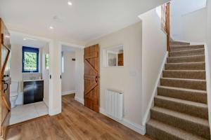 a staircase in a home with white walls and wood floors at 2 Bed in Feering oc-p29293 in Feering