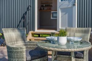 a table with bowls and glasses on a patio at 1 Bed in Saltfleetby oc-b30072 in Saltfleetby Saint Peter