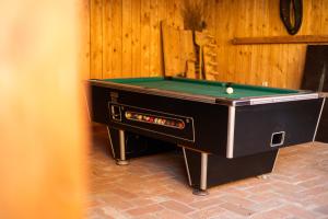 a pool table sitting on top of a brick floor at Selská chalupa Anetka in Horšovský Týn