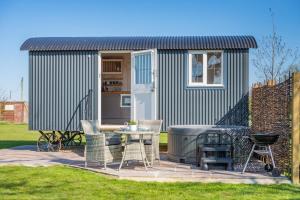 a tiny house with a grill and a table at 1 Bed in Saltfleetby oc-b30072 in Saltfleetby Saint Peter