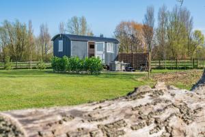 a tiny house in a field with a fence at 1 Bed in Saltfleetby oc-b30072 in Saltfleetby Saint Peter