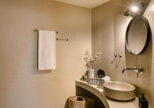 a bathroom with a sink and a mirror at Nomāde Agora Suites - Lixouri Town Centre, Kefalonia - Private Balconies in Lixouri