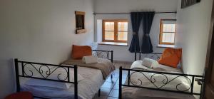 a small room with two beds and a window at L'instant doré in Charnay