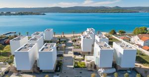an aerial view of white buildings next to a body of water at Villa Valea - Managed by Excelsior Villas in Turanj