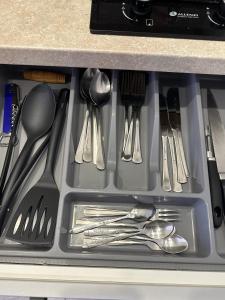 a drawer filled with silver utensils in a kitchen at Studio between two stations in Šiauliai