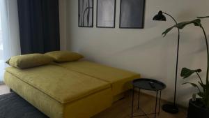 a bedroom with a bed and a lamp and a plant at Apartmán Jungmannka in Bruntál