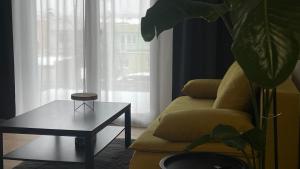 a living room with a couch and a coffee table at Apartmán Jungmannka in Bruntál
