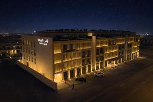 a building with a sign on the side of it at night at Azha Alriyadh in Riyadh