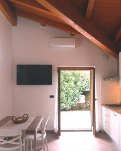a dining room with a table and a television on the wall at Residence Il Casolare in Piedimonte San Germano