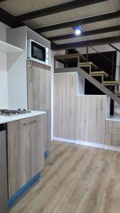 a kitchen with wooden cabinets and a tv on the wall at Apartamento 05 6ta Av Zona 1 Edificio Edwards in Las Victorias