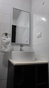 a bathroom with a white sink and a mirror at Apartamento 05 6ta Av Zona 1 Edificio Edwards in Las Victorias