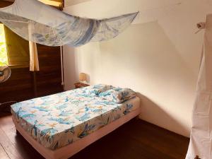 a bedroom with a bed with a mosquito net at lakazatypique in Saint-Laurent du Maroni