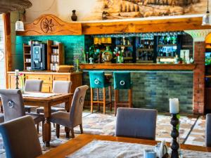 a restaurant with a table and chairs and a bar at Butikowy Hotel Zameczek in Książ Wielki