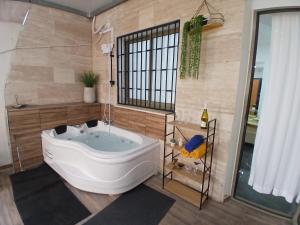 a bath tub in a bathroom with a tub at חופשה בממלכה in Ashkelon +18 photos