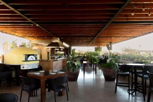 a restaurant with tables and chairs and a kitchen at Sol de Cabo in San José del Cabo
