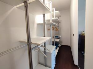 a staircase in a room with white shelves at Designer Apartement mit Kamin in Hartberg