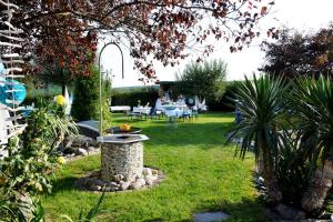 a garden with a bird bath in the grass at Designer Apartement mit Kamin in Hartberg