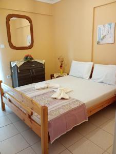 a bedroom with a large bed with a mirror at Katerina Apartments in Flogita