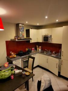 a kitchen with white cabinets and a table with a table sidx sidx at Snp 18 luxury in Košice