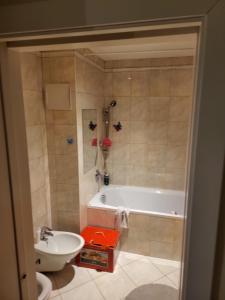 a bathroom with a tub and a toilet and a sink at Snp 18 luxury in Košice