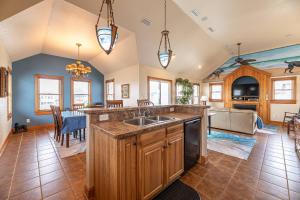 a large kitchen with a sink and a table at Happy Dog Days - Nags Head MP 11, Ocean View, 50 Yds to Beach, Elevator, Pool, Hot Tub, Pets OK, Flex Stays in Nags Head +58 photos