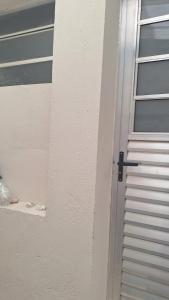 a door with a window next to a building at Casa kitnet in São Caetano do Sul