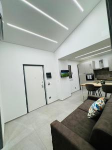 a living room with a couch and a table at Ponente Amato Home in Gaggi