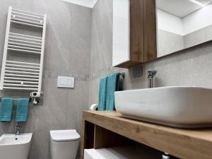 a bathroom with a white sink and a toilet at Ponente Amato Home in Gaggi