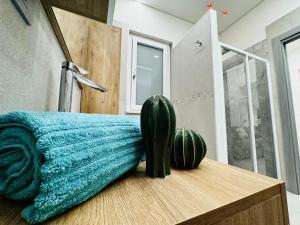 a bedroom with a cactus sitting on a wooden table at Ponente Amato Home in Gaggi