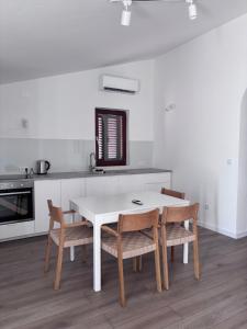 a kitchen with a white table and chairs at Villa Lulu in Orebić +63 photos