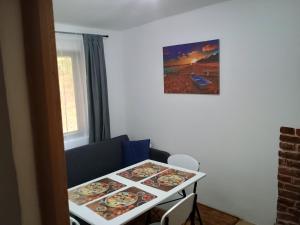 a table with plates on it in a room at Casa Padurarului in Ocnele Mari