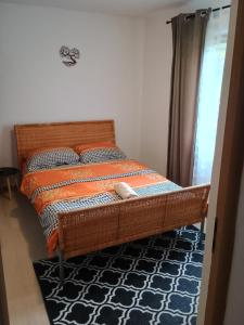 a bedroom with a bed with an orange and blue comforter at Casa Padurarului in Ocnele Mari +24 photos
