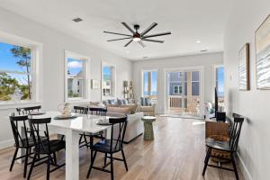 a dining room and living room with a table and chairs at Pet Friendly Beach House with Private Pool - Bella View in Port Saint Joe