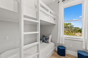 a white bunk bed in a bedroom with a window at Pet Friendly Beach House with Private Pool - Bella View in Port Saint Joe +31 photos