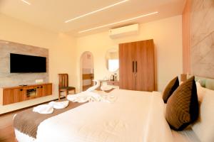 a hotel room with a bed with a swan on it at Holiday Heaven Munnar in Chinnakanal