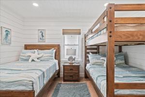 a bedroom with two beds and a bunk bed at Private Pool, Backyard, and Steps to the Beach in Cocoa Beach +52 photos