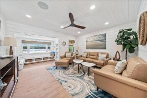 a living room with a couch and a table at Private Pool, Backyard, and Steps to the Beach in Cocoa Beach